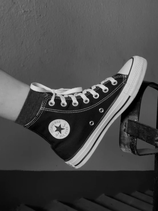 a black and white photo of a pair of shoes, a black and white photo, inspired by Elsa Bleda, trending on pexels, photorealism, converse, better known as amouranth, wearing black, ilustration