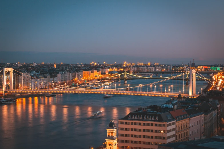 the city of budapest is lit up at night, pexels contest winner, viennese actionism, instagram post, high quality print, warm light, ocean view