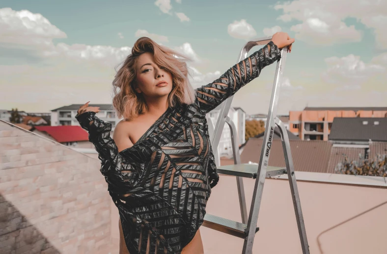 a woman standing on top of a roof next to a ladder, an album cover, by Robbie Trevino, trending on pexels, happening, fit curvy physique, chloe bennet, an asian woman, fishnet clothes