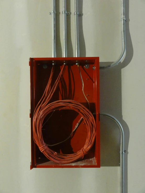 a close up of a box with wires in it, architectural, red, recessed, steel plating