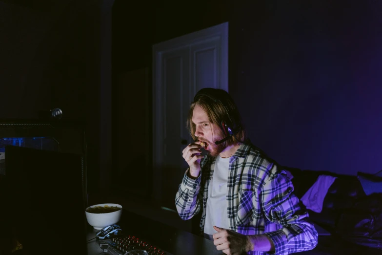 a man sitting at a table talking on a cell phone, digital art, inspired by Elsa Bleda, pexels, hyperrealism, playing computer games, purple lighting, smoking a bowl of hash together, standing in a dimly lit room