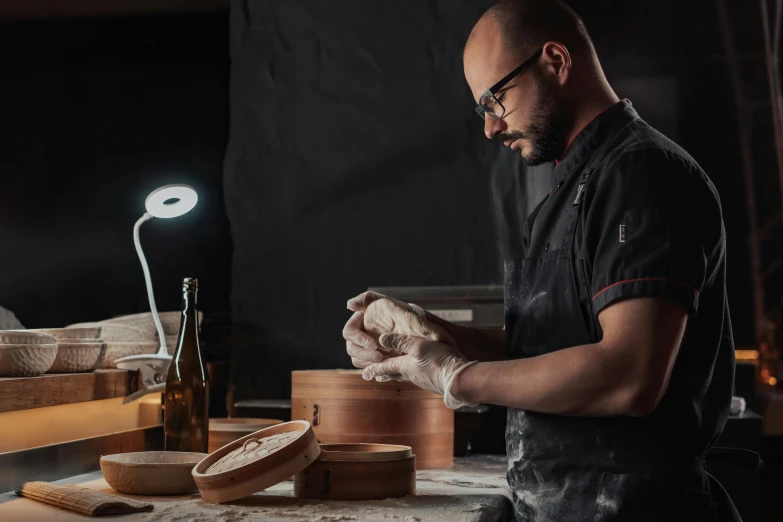 a man standing in a kitchen preparing food, a portrait, inspired by Francesco Raibolini, pexels contest winner, arbeitsrat für kunst, professional woodcarving, on a dark background, avatar image, baking french baguette