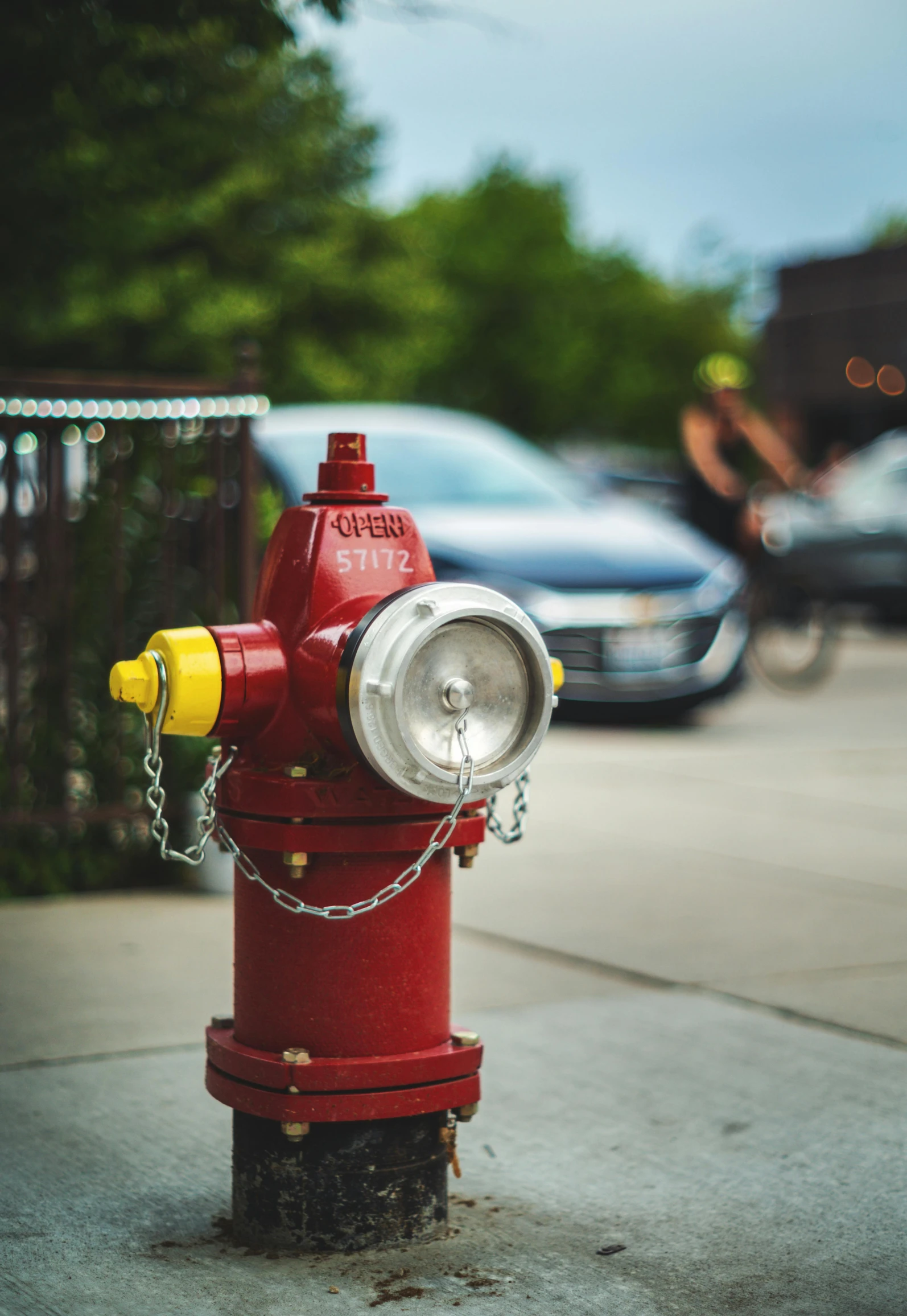 a red fire hydrant sitting on the side of a road, a tilt shift photo, by Jason Felix, pexels contest winner, street art, square, bright lights, where a large, a wooden