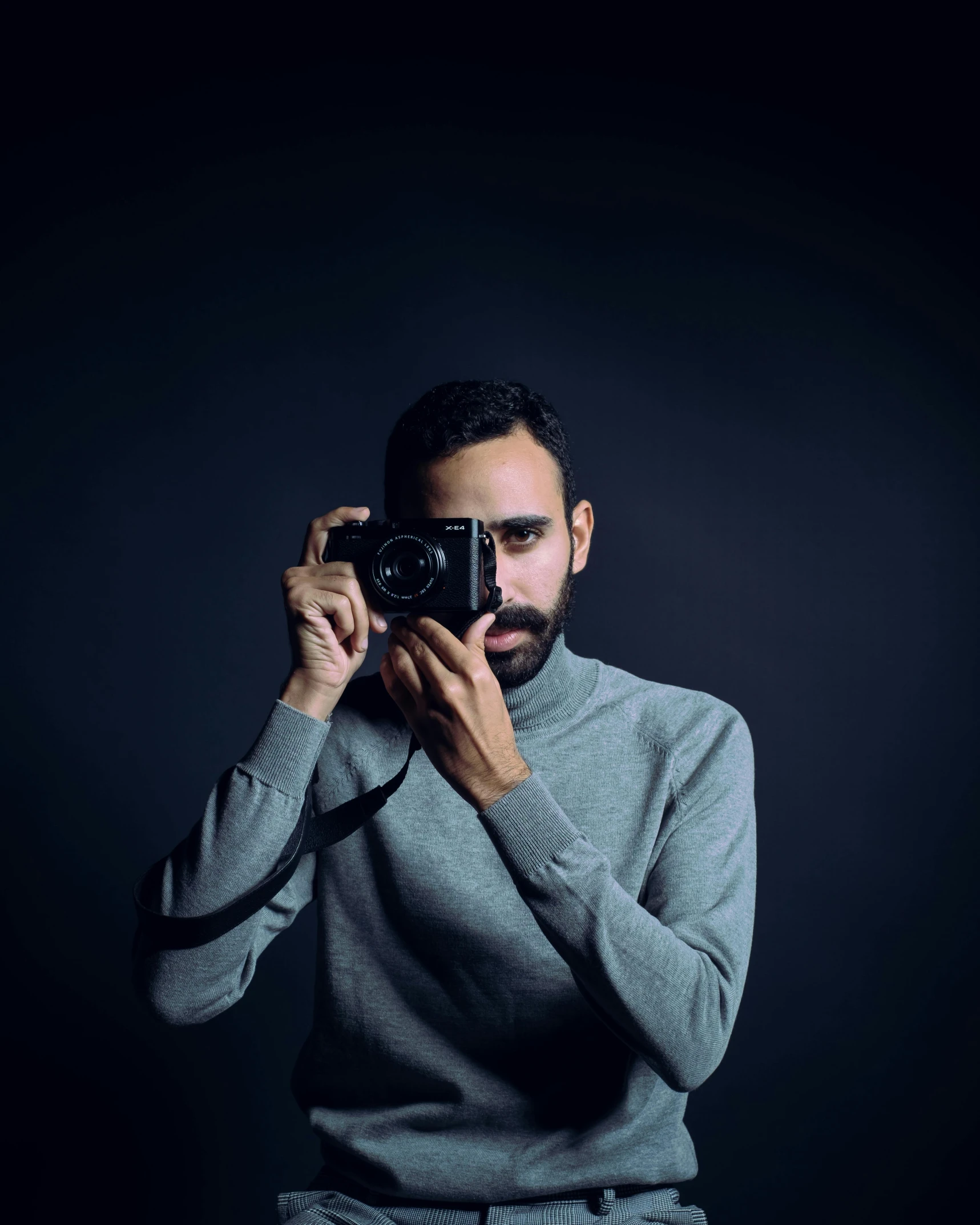 a man taking a picture with a camera, by Ismail Acar, standing with a black background, avatar image