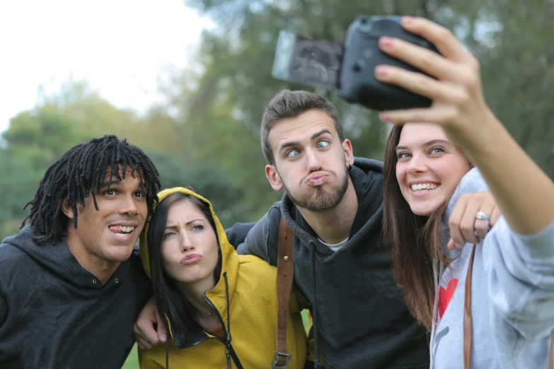 a group of friends taking a selfie in a park, by Paul Davis, pexels, happening, staring hungrily, square, mixed race, promotional image