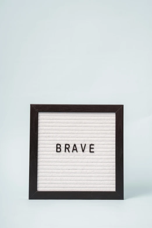 a letter board with the word brave written on it, a picture, trending on pexels, on a pale background, 1 8, brawl, productphoto