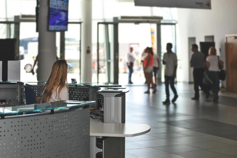 a group of people walking through a lobby, pexels contest winner, happening, console and computer, at the counter, in legnica city hall, black. airports