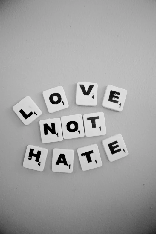 the word love not hate spelled in scrabbles, a black and white photo, pixabay, anti - communist, neutral expressions, an evil, tumblr aesthetic