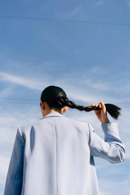 a woman is flying a kite in the sky, an album cover, inspired by Ren Hang, trending on unsplash, surrealism, hair in a ponytail, woman in business suit, hair blue two long braids, 15081959 21121991 01012000 4k