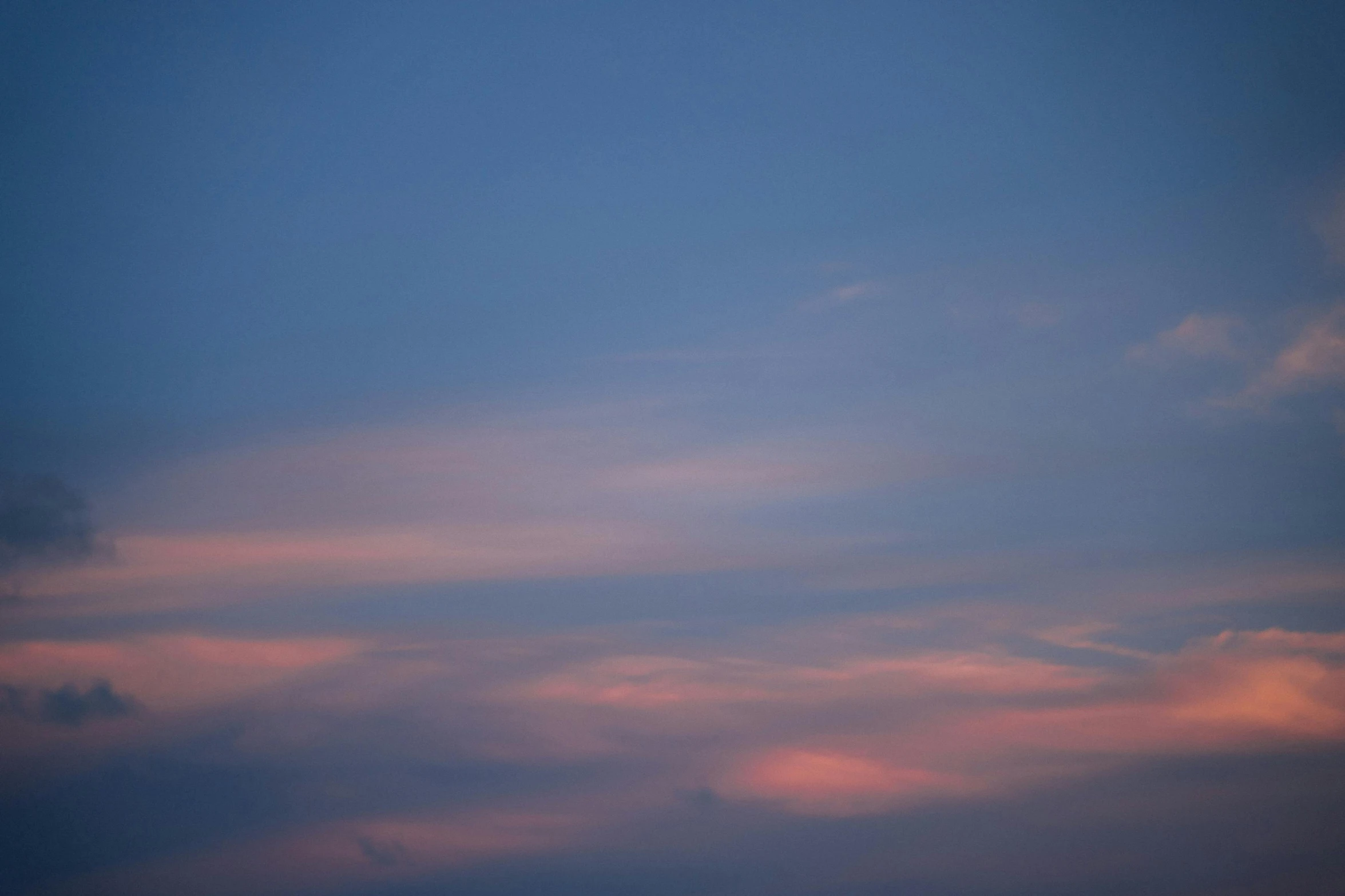 a plane that is flying in the sky, by Carey Morris, postminimalism, ((sunset)), blue and pink, closeup photograph, crepuscule