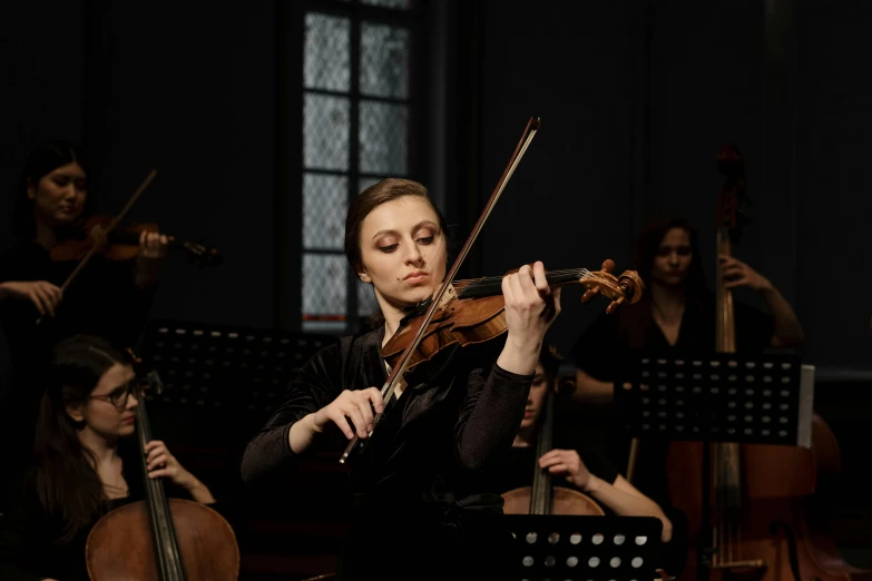 a woman in a black dress playing a violin, an album cover, pexels contest winner, baroque, live performance, square, [ cinematic, 2022 photograph