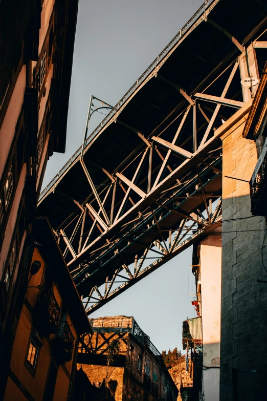 a bridge that is over some buildings, unsplash contest winner, laquer and steel, calcutta, strong sunlight, brown