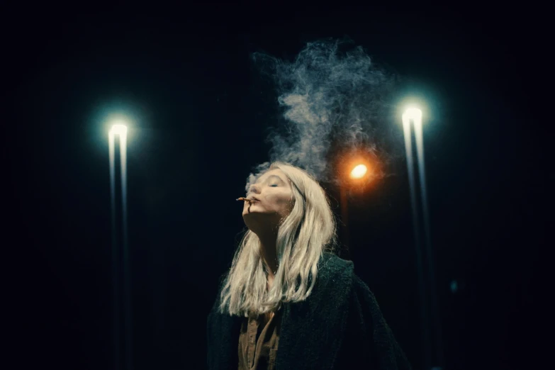 a woman smokes a cigarette in the dark, an album cover, inspired by Elsa Bleda, pexels contest winner, magical realism, white hair floating in air, worksafe. cinematic, movie still 8 k, gloomy lights in the sky