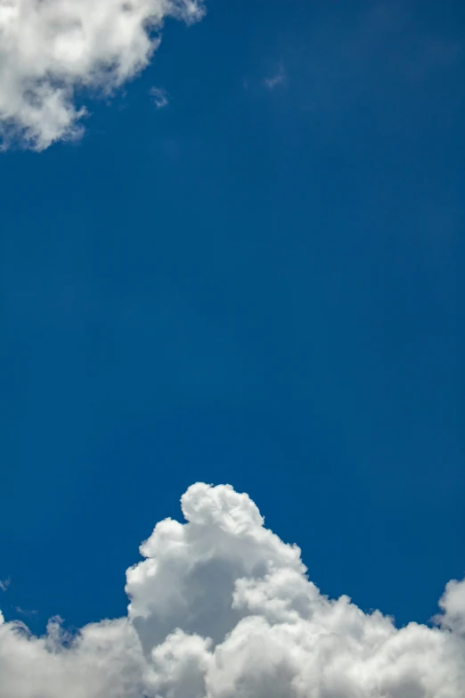 a jetliner flying through a cloudy blue sky, inspired by Rene Magritte, minimalism, f/3.5, new mexico, up-close, f/1.8