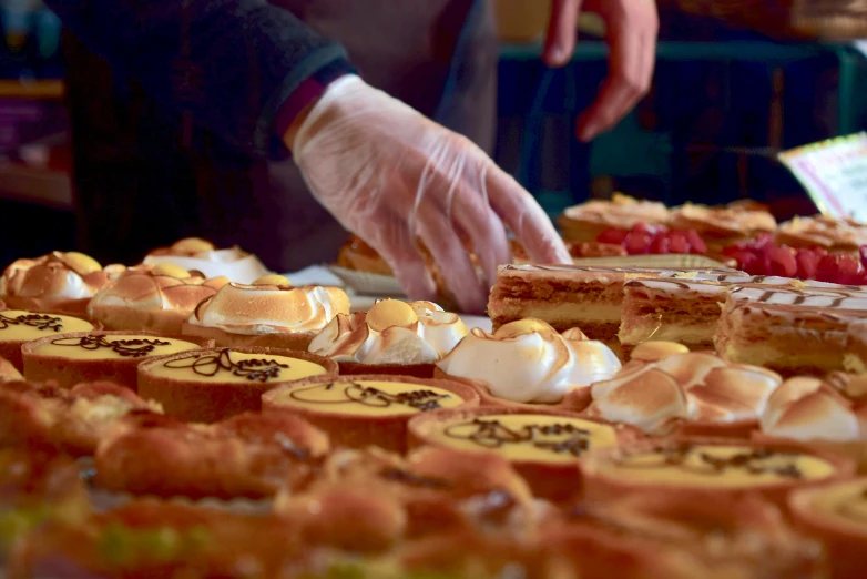 a table topped with lots of different types of pastries, by Lee Loughridge, pexels, hyperrealism, cake in hand, profile image, belgium, market