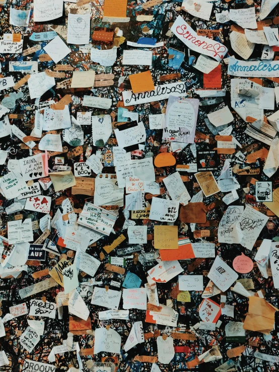 a wall covered in lots of post it notes, an album cover, by Howardena Pindell, trending on unsplash, arc de triomphe full of graffiti, close up 1 9 9 0, brown, in tokio