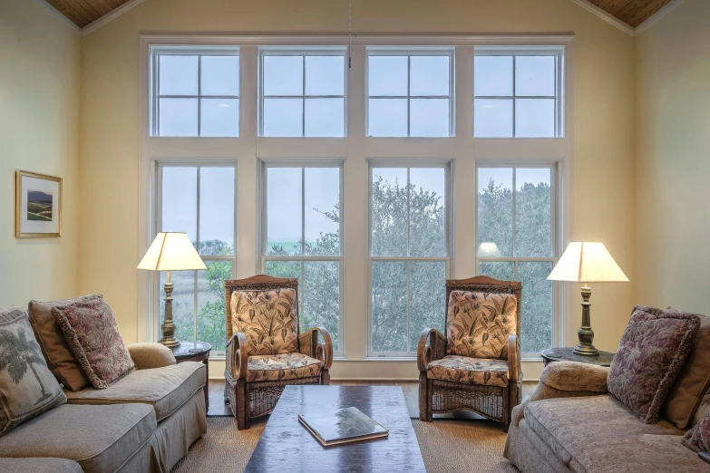 a living room filled with furniture and a large window, by Carey Morris, pexels, fake windows, panels, front lit, scenic view