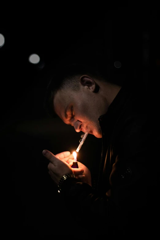 a man lighting a cigarette in the dark, ryan jia, licking out, candle lighting, profile image