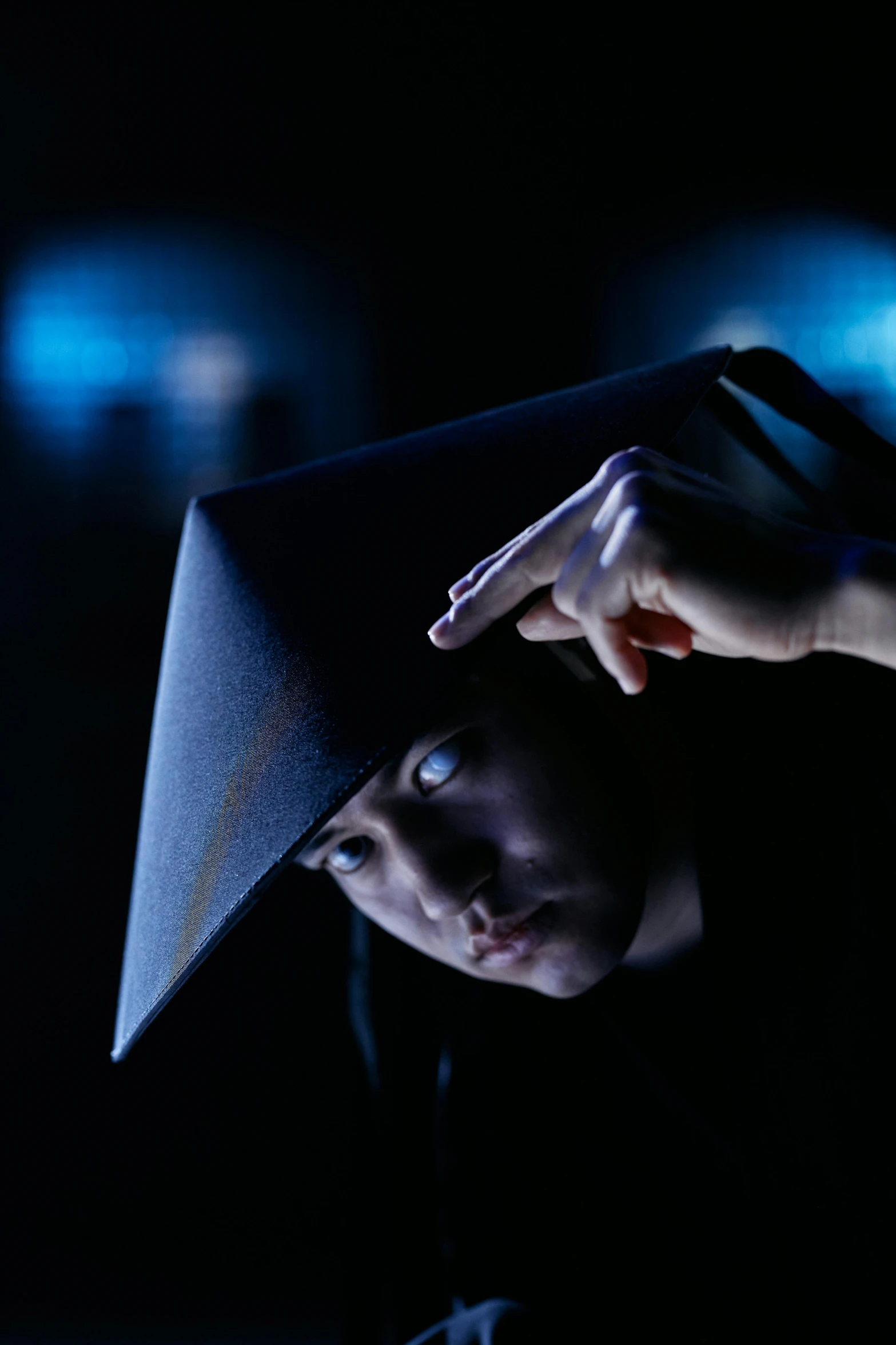 a close up of a person with a hat on, inspired by Uragami Gyokudō, unsplash, holography, evil pose, young wizard, oversized shuriken, photographed for reuters