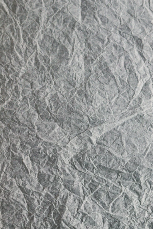 a man riding skis down a snow covered slope, an ultrafine detailed painting, inspired by Grillo Demo, paper crumpled texture, gunmetal grey, medium closeup, made of silk paper