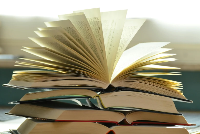 a stack of books sitting on top of a table, open books, passages, readability, thumbnail