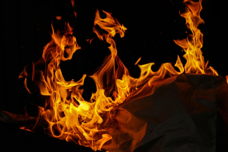 a pile of paper sitting on top of a fire, an album cover, pixabay, visual art, skin of flames, walking out of flames, hot food, close-up shoot