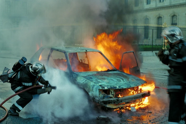 a fireman using a hose to exting a car on fire, a photo, by Pablo Rey, square, early 2 0 0 0 s, riot, getty images