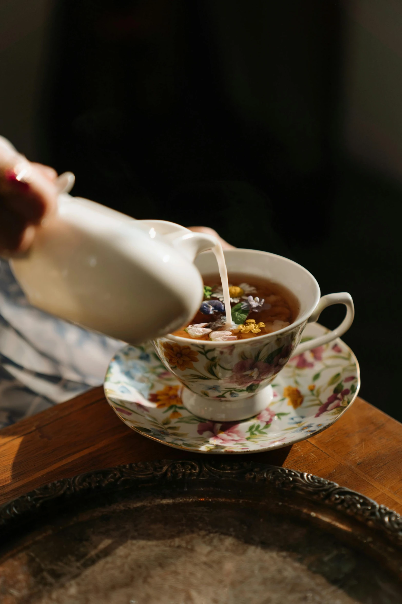 a person pouring something into a cup on a saucer, floral dream, “ iron bark, good soup, vintage vibe
