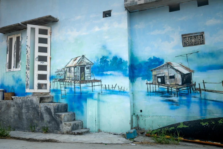 a painting on the side of a building, by Yi Insang, pexels contest winner, flooded fishing village, shades of blue and grey, cambodia, thumbnail