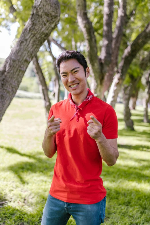 a man in a red shirt standing in a park, handsome chad chin, celebrating, kiseijuu, wearing polo shirt