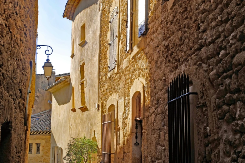 a couple of people that are walking down a street, by Bernard D’Andrea, pexels contest winner, romanesque, lourmarin, sunlight and whimsical houses, panoramic, high details!