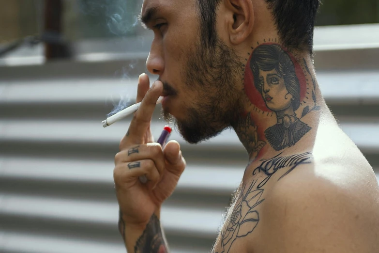 a man with tattoos smoking a cigarette, trending on pexels, jakarta, avatar image, gay, focused on neck