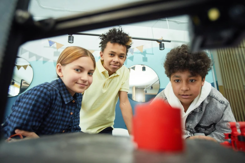 a group of children sitting around a table, 3 d printing, fan favorite, high-quality photo, commercially ready