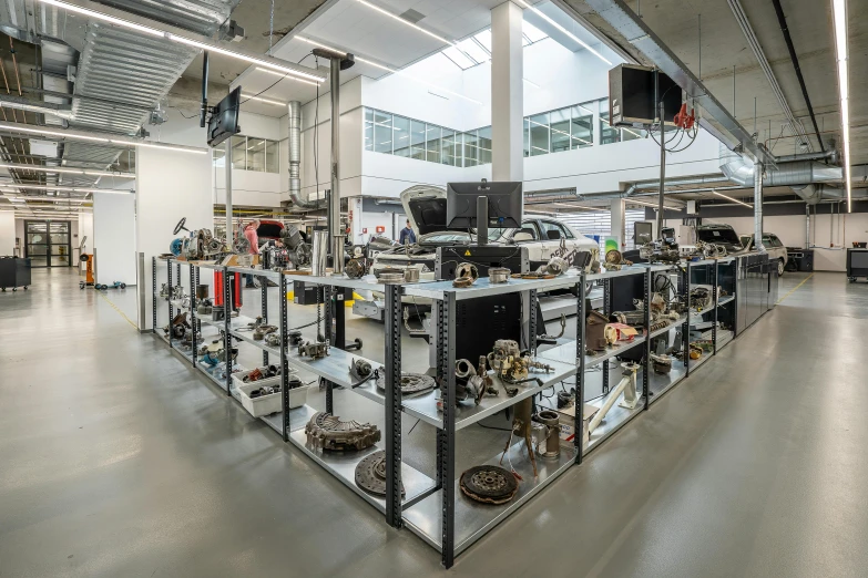 a room filled with lots of metal items, unsplash, modernism, formula 1 garage, mit technology review, exterior wide shot, cast
