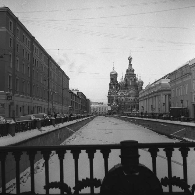 a black and white photo of a snowy street, a black and white photo, by Maurycy Gottlieb, flickr, socialist realism, railing along the canal, russian temple, cathedral, color image