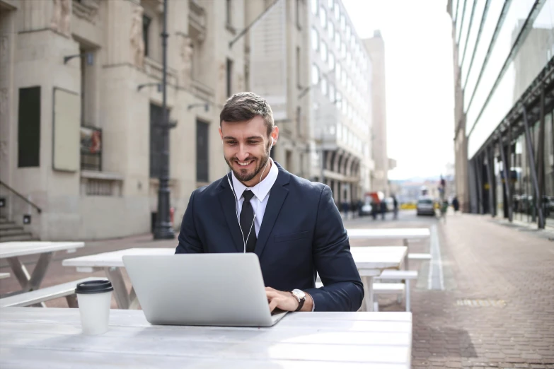 a man in a suit sitting at a table with a laptop, pexels contest winner, street level, avatar image, caucasian, maintenance