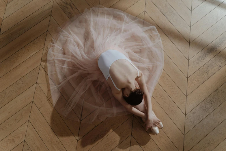 a woman in a tutu laying on the floor, by Elizabeth Polunin, pexels contest winner, arabesque, animation, france, soft vinyl, minimalist