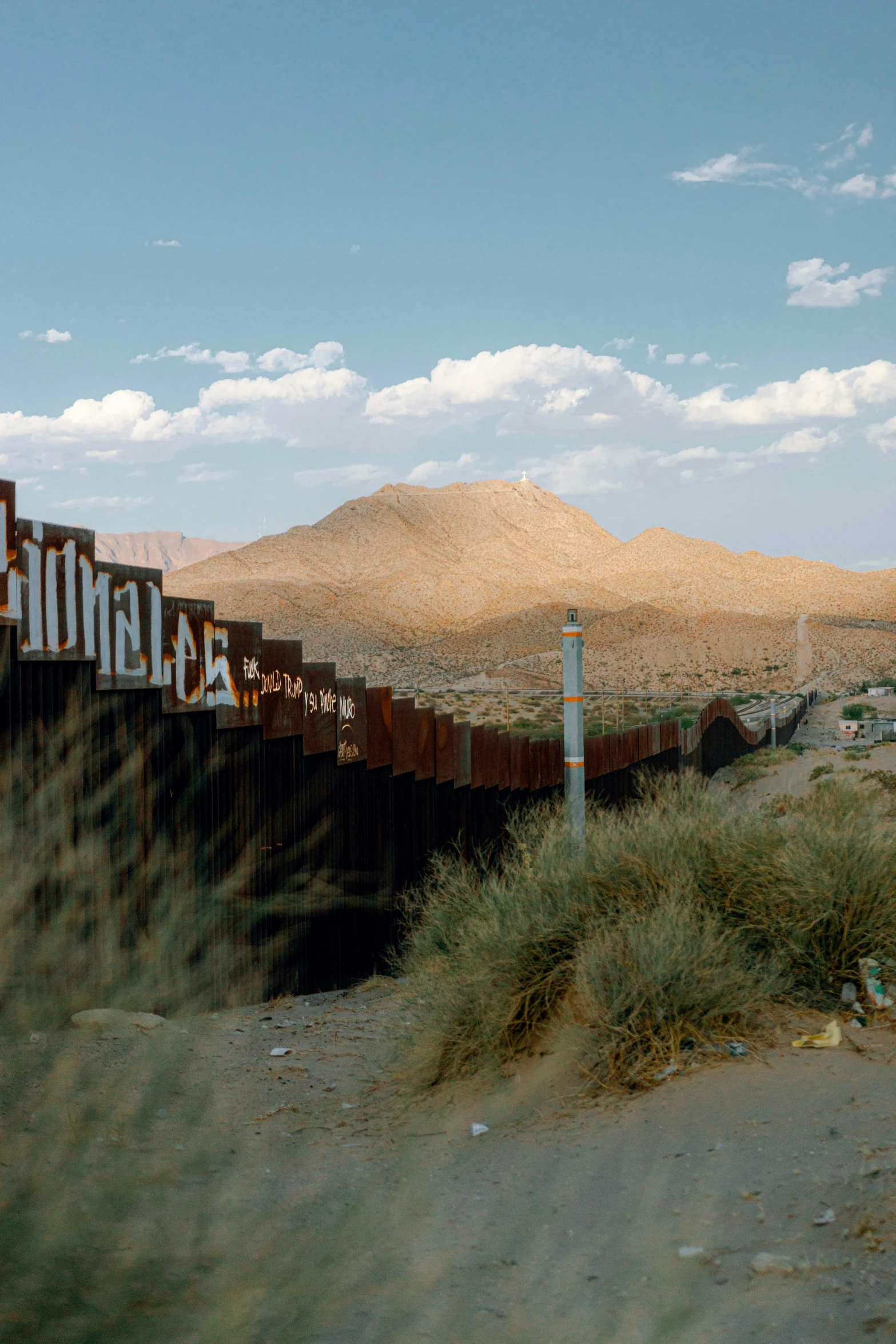 a train traveling over a bridge in the desert, by David Palumbo, trending on unsplash, graffiti, saguaro, pentagon, fence, mexican