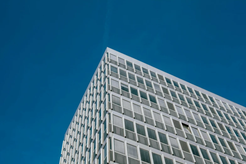 a tall white building with lots of windows, unsplash, bauhaus, sky blue, commercial, square lines, blue