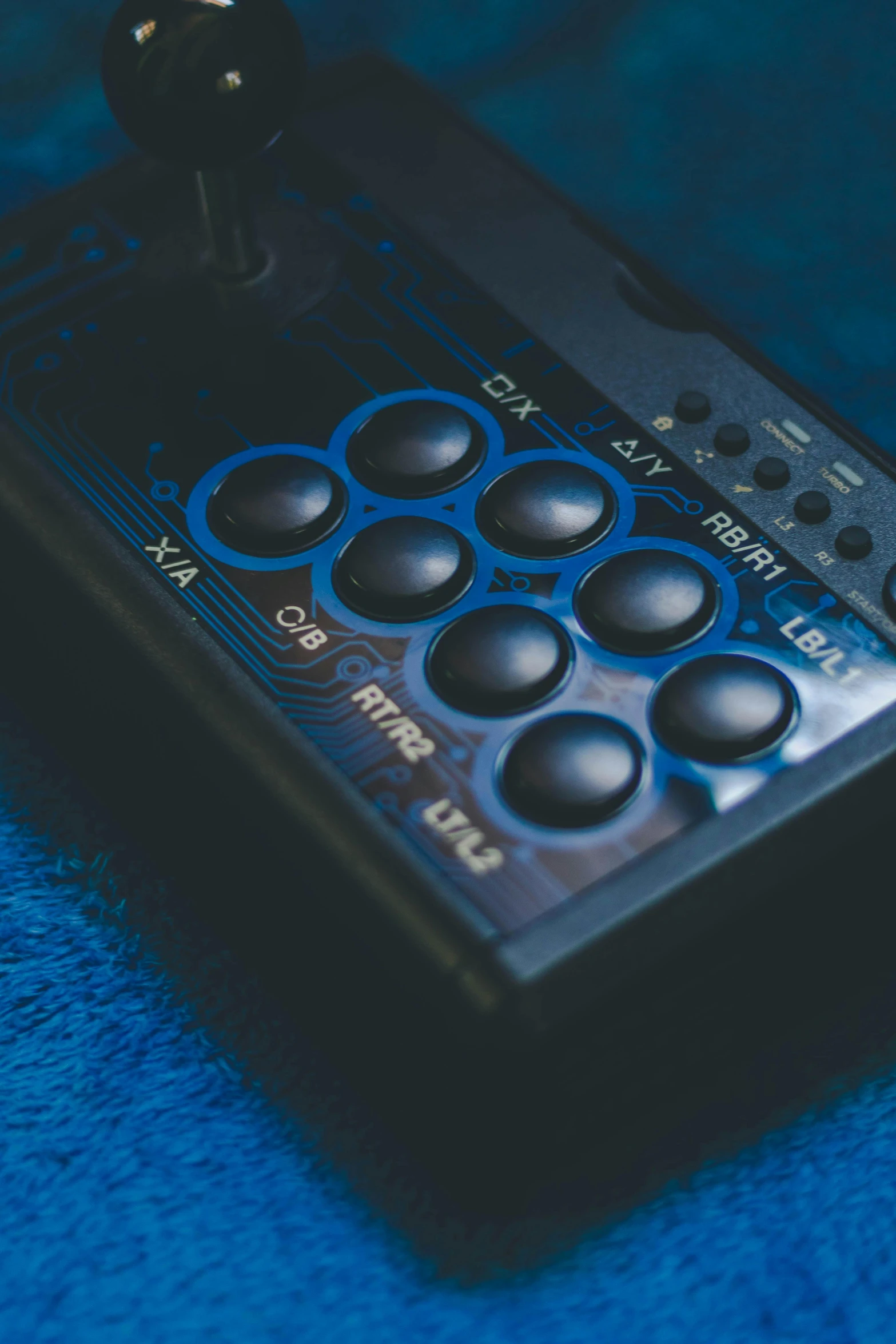 a video game controller sitting on top of a blue blanket, control panels, detailed product shot, ergodox, music