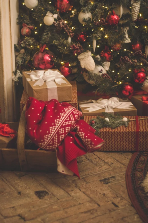 a dog sitting in front of a christmas tree, red and gold cloth, laying under a tree on a farm, birthday wrapped presents, alessio albi