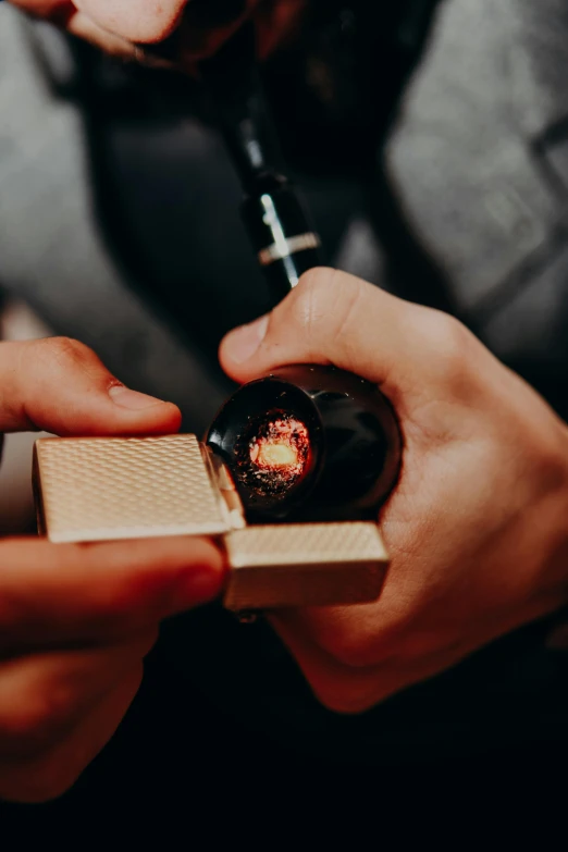 a close up of a person holding a cigarette, carbide lamp, inside of a black hole, carefully crafted, luxury materials