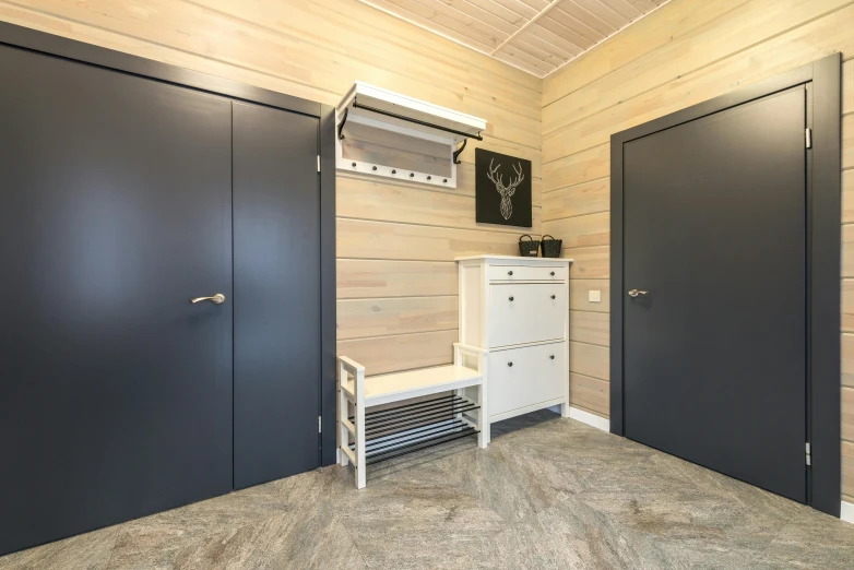 a room with two black doors and a white bench, by Daarken, professional picture, inside of a cabin, anthracite, lockers