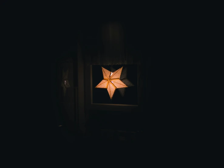 a lighted star in the window of a dark room, pexels contest winner, lantern, centered in a frame, decoration, instagram post