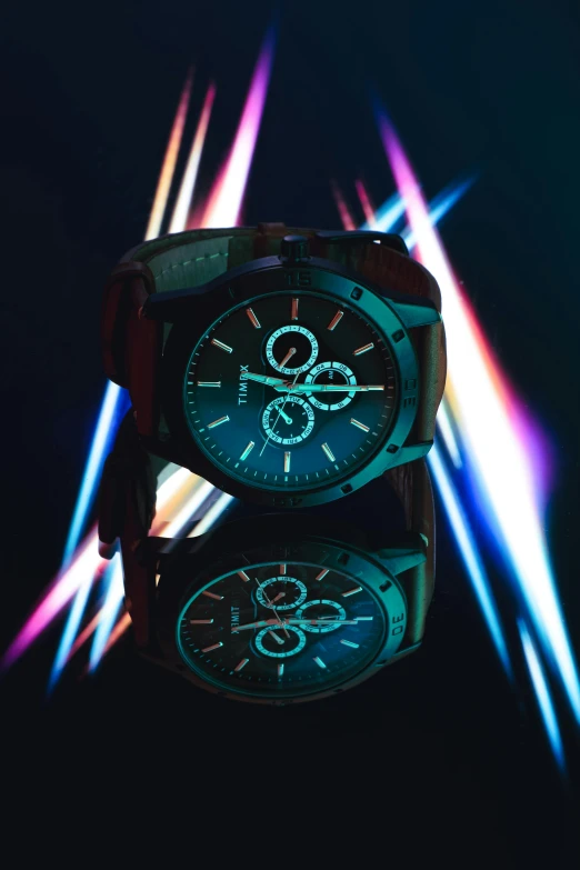 a couple of watches sitting on top of each other, inspired by Liam Wong, trending on pexels, photorealism, glowing with colored light, avatar image, detailed product shot, lightshow