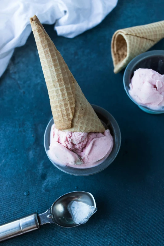 a couple of bowls filled with ice cream, faded pink, cone shaped, unsplash photo contest winner, ice blue