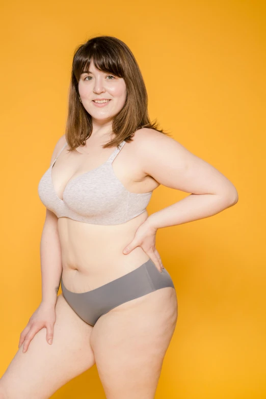 a woman in underwear posing for a picture, a colorized photo, by Taiyō Matsumoto, unsplash, rebecca sugar, gigantic size, flat grey, in good physical shape