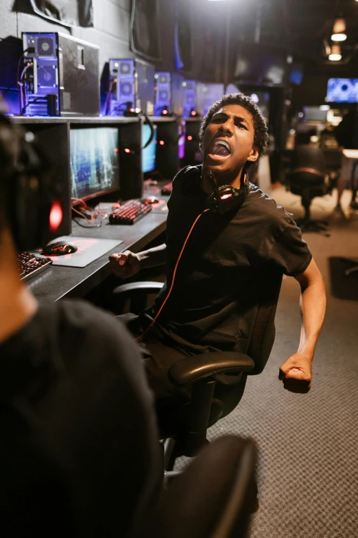 a man sitting in front of a computer desk, happening, battle action pose, screaming at the camera, riyahd cassiem, server in the middle