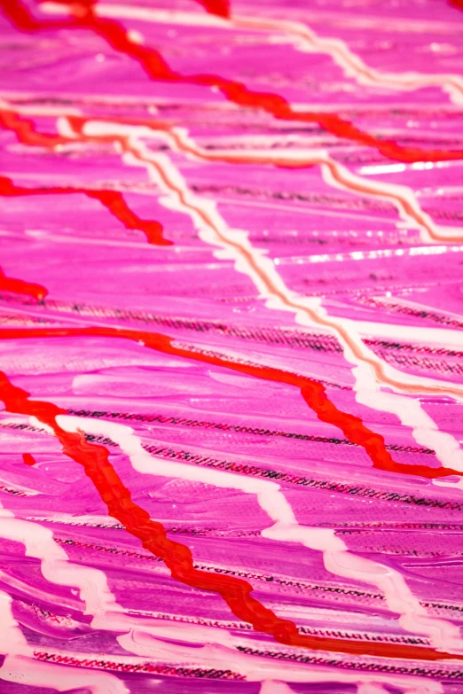 a close up of a piece of fabric on a table, inspired by Kenneth Noland, lyrical abstraction, pink neon lights, intricate oil sweeps, red grass, ( ( abstract ) )