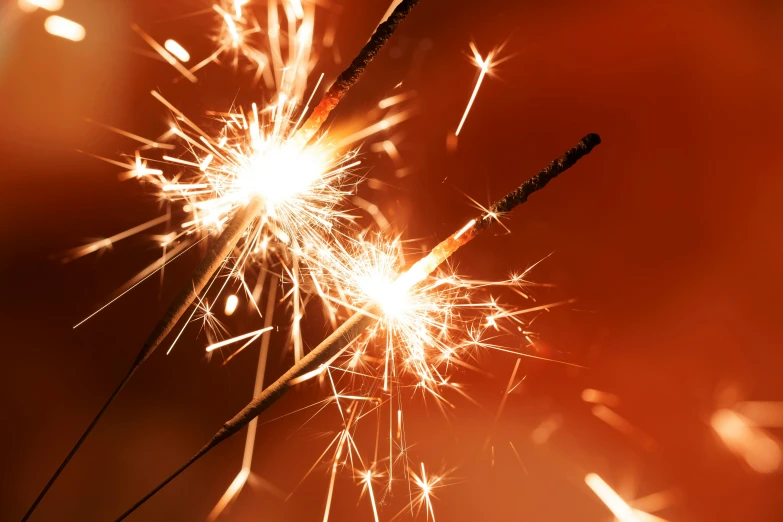 a couple of sparklers sitting on top of a table, pexels, happening, shining gold and black and red, spangled, a brightly coloured, bright flare